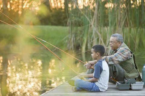 grootvader en kleinzoon vissen op de pier