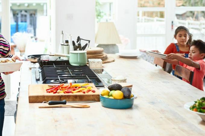 vrouw met hete braadpanschotel in de keuken